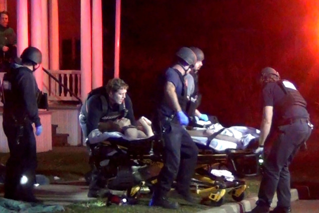  First responders wheel a victim to an ambulance after a gunman shot and wounded three college students of Palestinian descent in Burlington, Vermont, U.S. November 25, 2023 in a still image from video.  (credit: Courtesy Wayne Savage via REUTERS./File Photo)