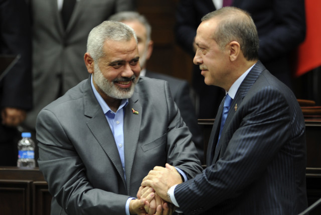  Turkey's Prime Minister Recep Tayyip Erdogan (R) and Hamas' Gaza leader Ismail Haniyeh shake hands during a meeting at the Turkish parliament in Ankara January 3, 2012 (credit:  REUTERS/Stringer)