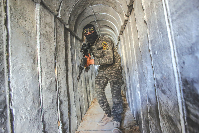 A terrorist from the al-Quds Brigades, the military wing of the Palestinian Islamic Jihad, is seen inside a military tunnel in Beit Hanun, in the Gaza Strip. (credit: ATTIA MUHAMMED/FLASH90)