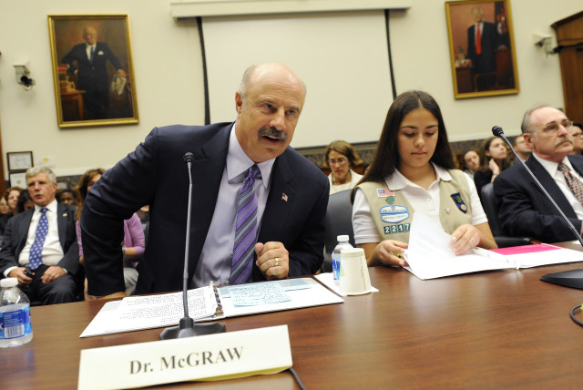  Dr. Phil McGraw (L), television personality and psychologist, prepares to testify to Congress in June 2010. (credit: REUTERS/JONATHAN ERNST)