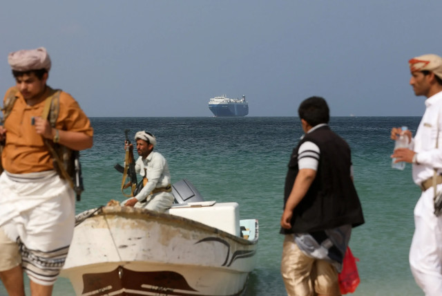  Armed men watch the ''Galaxy Leader'' ship that the Houthis took over to the coast of Yemen, December 5, 2023 (credit: REUTERS)