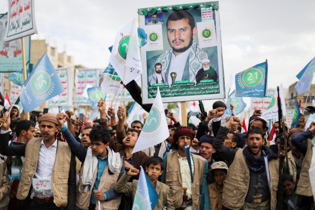 Supporters of Yemen's Houthis hold a poster of the top Houthi leader Abdul-Malik Badruddin al-Houthi during a rally in Sanaa in September 2021. (credit: REUTERS)
