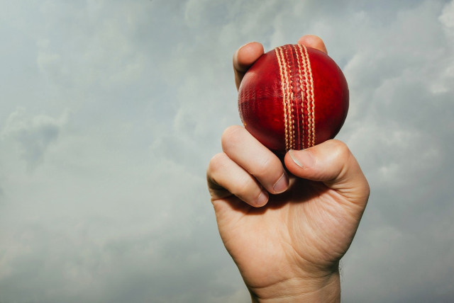  A hand holding a cricket ball. (credit: PakTribune)