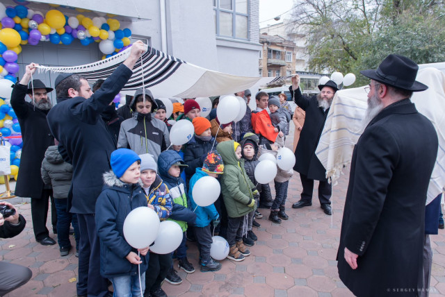  Children and rabbis celebrate opening of new children's home facility. (credit: CHABAD)