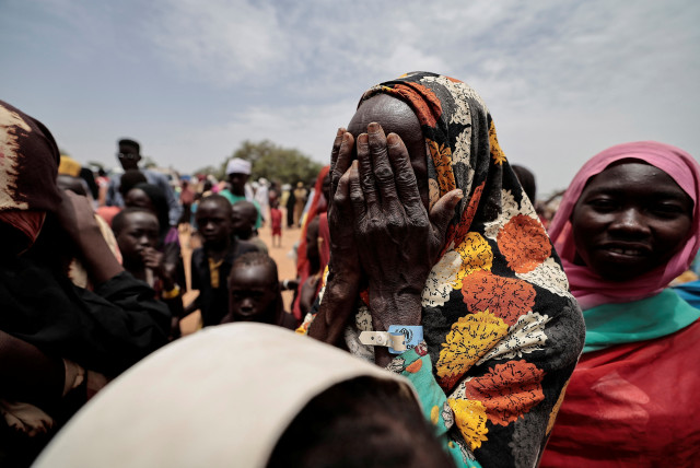  A Sudanese woman, mourns her son and a relative, who according to her were killed by Rapid Support Forces (RSF), in Ourang on the outskirts of Adre, Chad July 25, 2023 (credit: REUTERS/ZOHRA BENSEMRA)