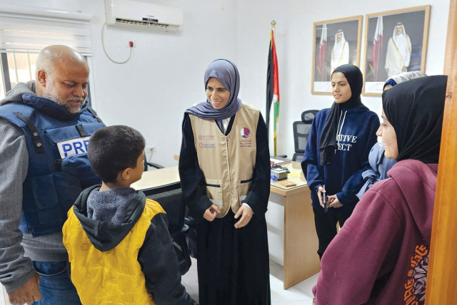  Qatari Minister of State for International Cooperation Lolwah Bint Rashid Al Khater talks to a Palestinian boy as she visits Gaza during a temporary truce between Israel and Hamas on November 26. (credit: Qatar’s Ministry of Foreign Affairs/Reuters)
