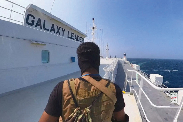  A HOUTHI TERRORIST guards the deck of the ‘Galaxy Leader’ cargo ship in the Red Sea last month. (credit: Houthis/via Reuters)
