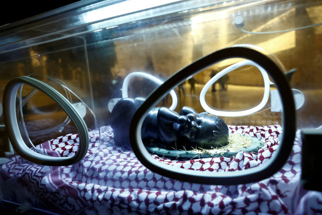  An installation by Rana Bishara shows a figure of baby Jesus, made by Sana Fara Bishara, inside an incubator in front the Church of the Nativity in support of Gaza, in Bethlehem, in the West Bank, December 24, 2023. (credit: CLODAGH KILCOYNE/REUTERS)