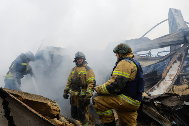 Firefighters work amid debris of the destroyed shopping mall Galaktika that was hit by recent shelling in the course of Russia-Ukraine conflict in the town of Horlivka (Gorlovka) in the Donetsk region, Russian-controlled Ukraine, December 25, 2023.  (credit: REUTERS/ALEXANDER ERMOCHENKO)