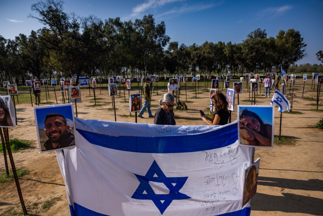 People visit the site of the Nova music festival massacre, in Re'im, near the Israeli-Gaza border, December 31, 2023 (credit: YONATAN SINDEL/FLASH90)