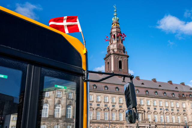 Flags flutter on the Christiansborg Palace People in Copenhagen, Denmark (credit: RITZAU SCANPIX/NIELS CHRISTIAN VILMANN VIA REUTERS)
