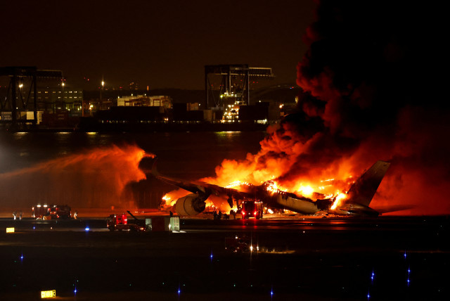  Firefighters work at Haneda International Airport after Japan Airlines' A350 airplane caught on fire, in Tokyo, Japan January 2, 2024. (credit: REUTERS/ISSEI KATO)