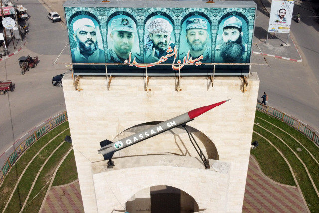  A picture taken with a drone shows a monument of a Hamas rocket with pictures of late commanders from armed Palestinian factions, in Rafah in the southern Gaza Strip February 2, 2021 (credit: REUTERS/MOHAMMED SALEM)