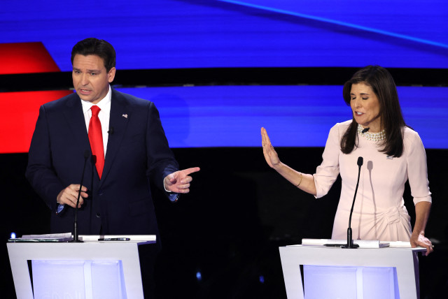  Florida Governor Ron DeSantis and Former U.S. Ambassador to the United Nations Nikki Haley discuss an issue as they participate in the Republican candidates' presidential debate hosted by CNN at Drake University in Des Moines, Iowa, U.S. January 10, 2024. (credit: REUTERS/MIKE SEGAR)