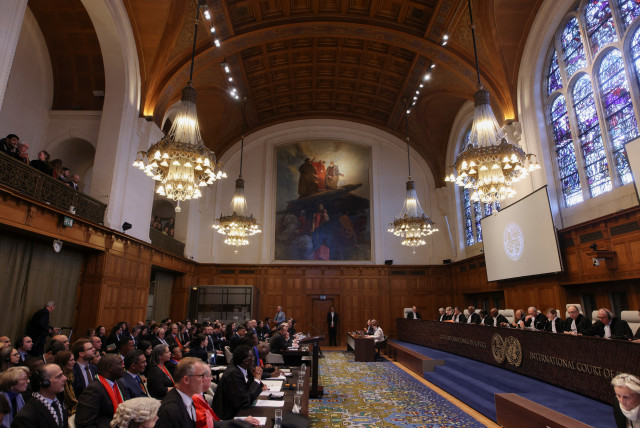  People sit inside the International Court of Justice (ICJ) on the day of the trial to hear a request for emergency measures by South Africa, who asked the court to order Israel to stop its military actions in Gaza, The Hague, Netherlands, January 11, 2024 (credit: REUTERS/THILO SCHMUELGEN)