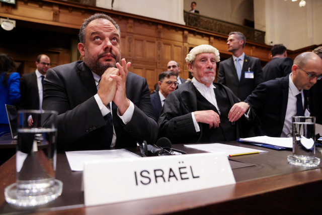  Legal adviser to Israel's Foreign Ministry Tal Becker and British jurist Malcolm Shaw sit inside the International Court of Justice (ICJ) as judges hear a request for emergency measures to order Israel to stop its military actions in Gaza, in The Hague, Netherlands January 12, 2024 (credit: REUTERS/THILO SCHMUELGEN)