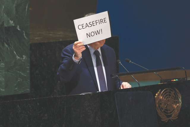  PALESTINIAN UN envoy Riyad Mansour holds up a sign calling for an immediate ceasefire in Gaza, as he speaks in the General Assembly Hall at UN headquarters in New York City, last week. The UN is losing its relevance fast, the writers argue. (credit: Shannon Stapleton/Reuters)