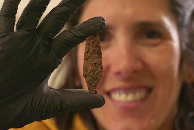  Excavation Director Michal Mermelstein with an Iron arrowhead from the First Temple period found at the site. (credit: Israel Antiquities Authority)