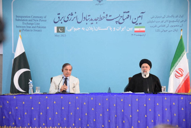 Pakistan's Prime Minister Shehbaz Sharif, and Iran's President Ebrahim Raisi speak during a Joint Inauguration of the Polan-Gabd Electricity Transmission Line, at Mand-Pishin border crossing point, in Pishin, Pakistan May 18, 2023. (credit: Press Information Department (PID)/Handout via REUTERS)