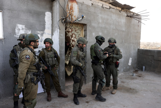 Israeli soldiers stand as they operate, amid the ongoing conflict between Israel and the Palestinian Islamist group Hamas, in Gaza, January 8, 2024. (credit: REUTERS/Ronen Zvulun)