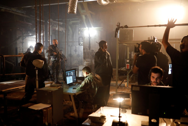  Actors and filming crew members work on the set of Israeli television series ''Fauda'' in Tel Aviv, Israel May 30, 2019. (credit: REUTERS/AMIR COHEN)