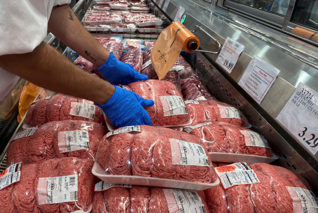  A worker stacks packets of ground beef in the meat section of a Costco warehouse  (credit:  REUTERS/Adrees Latif)