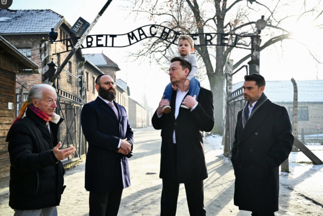 Businessman Elon Musk, third from right, and US political commentator Ben Shapiro, furthest right, visit the site of the Auschwitz-Birkenau death and concentration camp. (credit: YOAV DODKOVITZ)