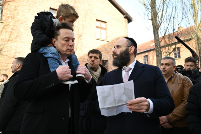  Businessman Elon Musk, left, visits the site of the Auschwitz-Birkenau death and concentration camp, January 22, 2024. (credit: YOAV DODKOVITZ)