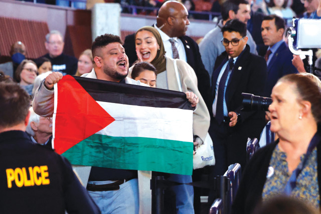  A PROTESTER holds a Palestinian flag as US President Joe Biden attends a presidential election campaign event in Manassas, Virginia, last week. The Palestinian flag has been featured at rallies, protests, and riots all over the world since the Palestinian massacre of innocent Jews on October 7. (credit: EVELYN HOCKSTEIN/REUTERS)