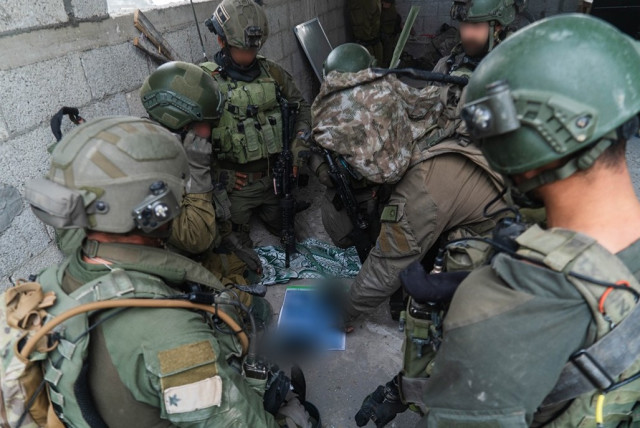  IDF soldiers uncover weapons, electronics in homes of terrorists in Gaza (credit: IDF SPOKESPERSON UNIT)