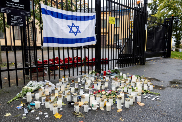  Flowers and candles are placed outside the Israeli embassy in Stockholm, Sweden, on October 11, 2023 (credit: VIA REUTERS)