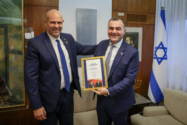  Knesset Speaker Amir Ohana receives a copy of the epic work The  Knight in the Panther's Skin from outgoing Georgian Ambassador Lasha Zhvania. (credit: COURTESY GEORGIAN EMBASSY)