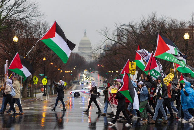  Pro-Palestine demonstrators cross New Jersey Avenue near the U.S. Capitol, during a protest in Washington, U.S, December 17, 2023. (credit:  REUTERS/TOM BRENNER)