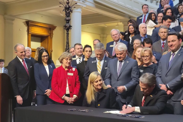  Gov. Kemp signs the antisemitism bill into law. Looking on, at far left, is IAC CEO Elan Carr.  (credit: IAC FOR ACTION)
