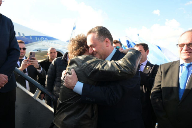  FM Israel Katz embraces Argentinian president Javier Milei shortly after the Argentinian head of state lands in Israel. February 6, 2024.  (credit: Shlomi Amsalem/Foreign Ministry)
