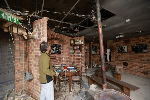  A man looks at the damage caused to the Yad Mordechai Museum from a rocket fired from the Gaza Strip a few weeks ago, in Kibbutz Yad Mordechai, on December 21, 2023 (credit: YOSSI ZAMIR/FLASH90)