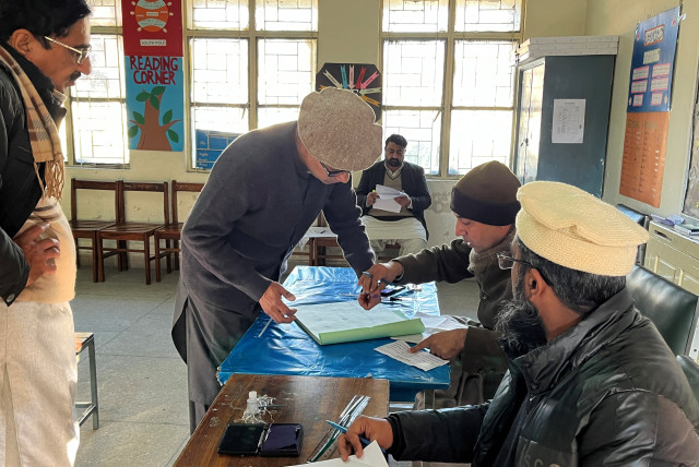 Businessman Imran Sheikh, 52, registers to vote at a polling station in a school on the day of the general election, in Islamabad, Pakistan February 8, 2024. (credit: REUTERS/Ariba Shahid)
