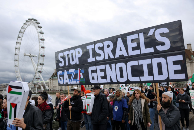  Demonstrators cross the Westminster Bridge as they participate in a silent procession during a vigil for Gaza, amid the ongoing conflict between Israel and the Palestinian Islamist group Hamas, in London, Britain February 10, 2024.  (credit: REUTERS/HOLLIE ADAMS)