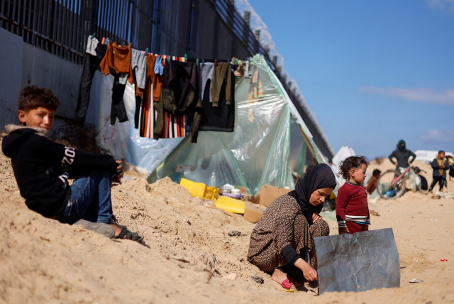 Displaced Palestinian woman Laila Abu Mustafa, who fled her house due to Israeli strikes, shelters at the border with Egypt, in Rafah in the southern Gaza Strip, February 10, 2024. (credit: REUTERS/MOHAMMED SALEM)