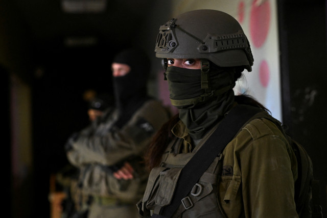  Israeli soldiers operate in a school, amid the ongoing conflict between Israel and Hamas, in the Gaza Strip, February 8, 2024 (credit: REUTERS/DYLAN MARTINEZ)