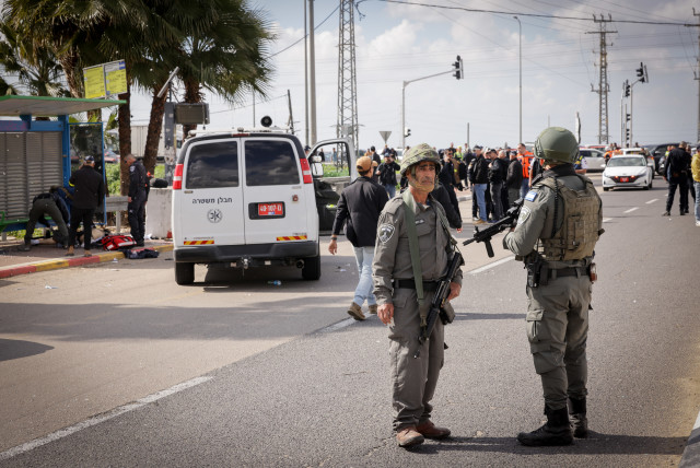 Israeli security seen near a terrorist at the scene of a shooting attack in Southern Israel.  February 16, 2024 (credit: NATI SHOHAT/FLASH90)