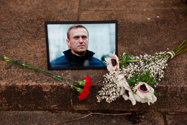  Flowers and a portrait of Russian opposition leader Alexei Navalny are seen near the Russian embassy in Paris, France, February 16, 2024 (credit: REUTERS/GONZALO FUENTES)