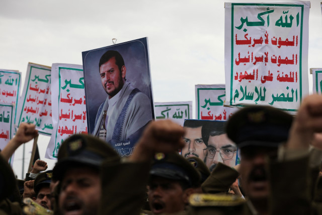  Demonstrators, predominantly Houthi supporters, hold a picture of the Houthi leader Abdul-Malik al-Houthi and signs as they rally to show support to the Palestinians in the Gaza Strip, amid the ongoing conflict between Israel and the Palestinian Islamist group Hamas, in Sanaa, Yemen February 16, 20 (credit: KHALED ABDULLAH/REUTERS)