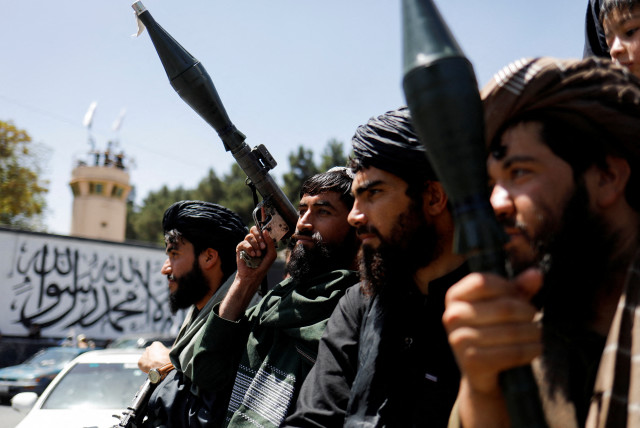  Taliban fighters celebrate on the second anniversary of the fall of Kabul on a street near the US embassy in Kabul, Afghanistan, August 15, 2023. (credit: REUTERS)