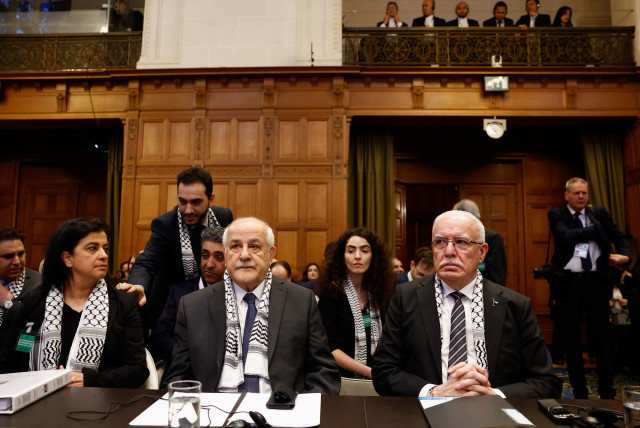 Palestinian Foreign Minister Riyad al-Maliki and Palestinian UN envoy Riyad Mansour attend a public hearing held by the International Court of Justice (ICJ) to allow parties to give their views on the legal consequences of Israel's ''occupation'' of the Palestinian territories. (credit: REUTERS/PIROSCHKA VAN DE WOUW)