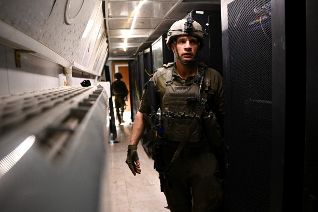  An Israeli soldier walks in what the military described as a Hamas command tunnel running partly under UNRWA headquarters, amid the ongoing conflict between Israel and the Palestinian Islamist group Hamas, in the Gaza Strip, February 8, 2024. (credit: DYLAN MARTINEZ/REUTERS)