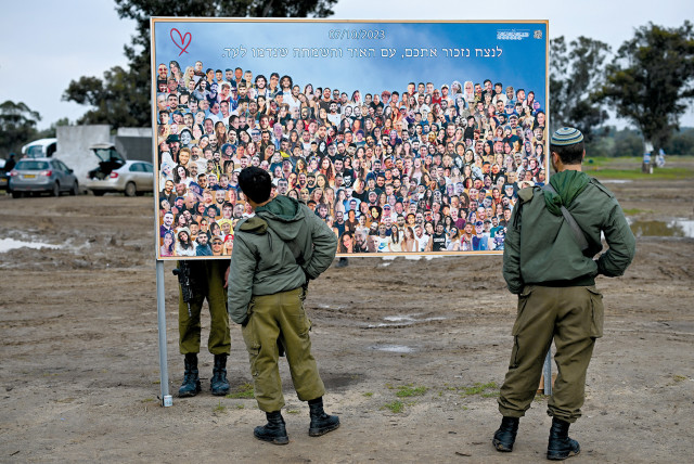  Soldiers visit the site of the Supernova music festival, where photographs are displayed of the people who were killed or kidnapped during the October 7 attack by Hamas.  (credit: DYLAN MARTINEZ/REUTERS)