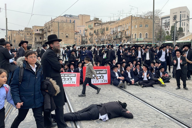 A group of ultra-Orthodox Jews blocked traffic and the light rail  in Jerusalem demonstrating against a Haredi draft into the IDF. February 26, 2024. (credit: SOL SUSSMAN)