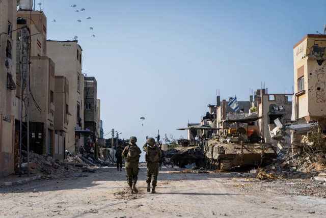  IDF soldiers in Gaza, while humanitarian aid is seen being airdropped to Gazan residents above, February 28, 2024. (credit: IDF SPOKESPERSON UNIT)
