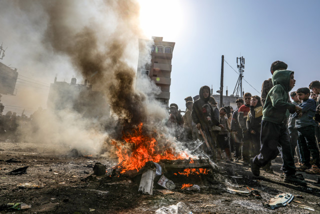  Palestinians burn tires during a protest against Hamas in Rafah, in the southern Gaza Strip, on February 28, 2024 (credit: ABED RAHIM KHATIB/FLASH90)